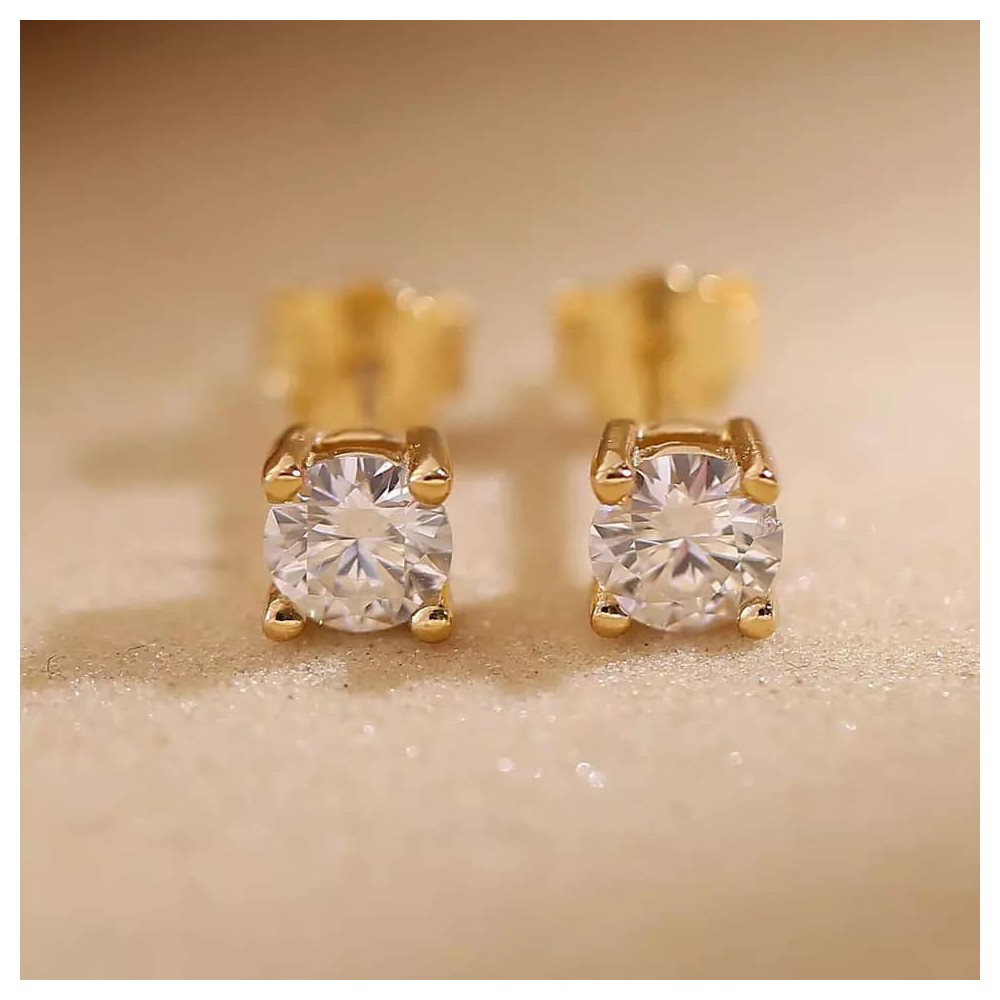 Quality stud earrings with zirkonia in steel/gold, different sizes.